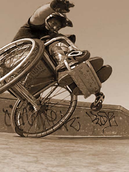 man in wheelchair on one wheel