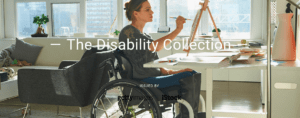 Woman wearing high boots, sitting in manual wheelchair paints at an easel in a light-filled apartment
