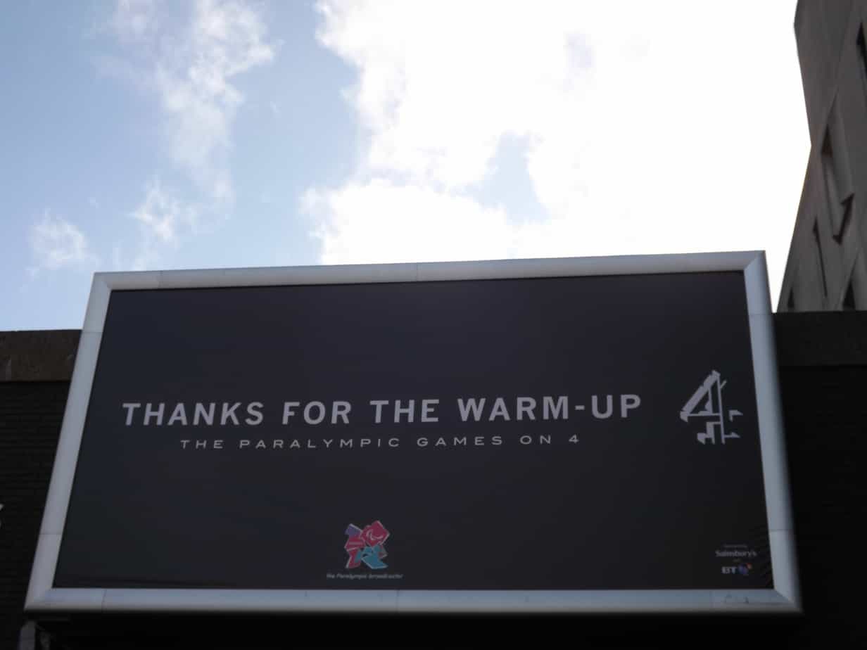 Black billboard with white text that reads: Thanks for the Warm Up - the Paralympics on Channel 4