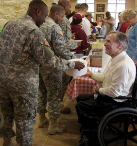 Greg Abbott passes out plates at a Wounded Warriors picnic.