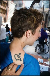 Annie designed the Wheelchair Heart symbol and had it tattooed on her shoulder. Today it's the symbol of the Day of Acceptance.