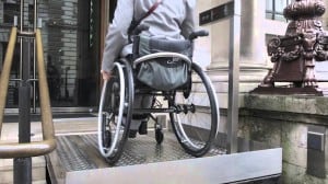 With the steps retracted, this wheelchair user rides the lift to the front door.