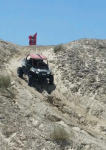 Dru Blocker drives his Polaris UTV in the desert hills.