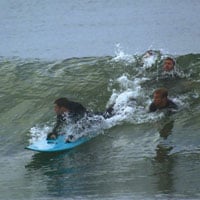 Jarred Evans, a C6 quad, surfs using a Billauer board.