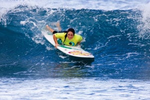 Ann Yoshida catches a wave in Hawaii.