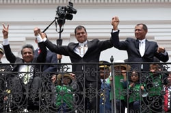 Ecuadorian Vice President Moreno clasps the hand of his president, Rafael Correa, on election night.