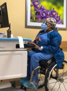 photo depicting her working calmly at her station to encourage others with disabilities who have to fight for their place on the hospital floor.