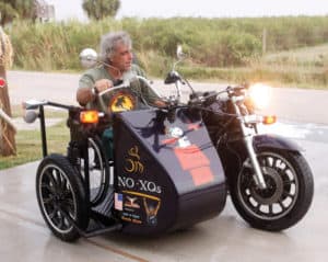 David Gaston drives his motorcycle from the sidecar, which has caused more than one motorist to look twice.