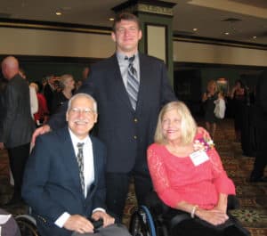 Paul and Anne Herman (seated) enjoy an awards ceremony with their son, Don.