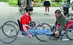 Ian Jaquiss (right), shown here teaching the fine points of hand-cycling, credits his good health to carefully monitoring his diet.