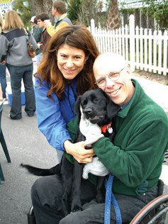 Frank and Adriana Barham mug for the camera with their “black-labbish” dog, Scooter.