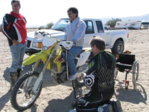 Lance Magin gets his feet zip-tied to his dirt bike for an early morning ride.