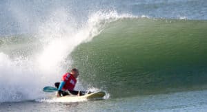 Mark Thornton starts a bottom turn on his wave ski during an adaptive surf contest in California.