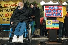 Now: In 2003, Kovic addresses a crowd in Los Angeles protesting the immininent war with Iraq. 