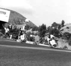 Eric Walls, left, and Brad Parks side wheelie “formation flying” down a steep hill near the Quadra factory.