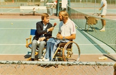 Brad Parks in his gold anodized Quadra is interviewed by Pat Sajak following a wheelchair tennis demo.
