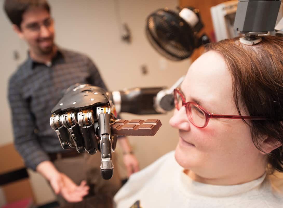 Jan Scheuermann has moved on from eating a chocolate bar with a robotic arm to flying fighter jets with her mind.