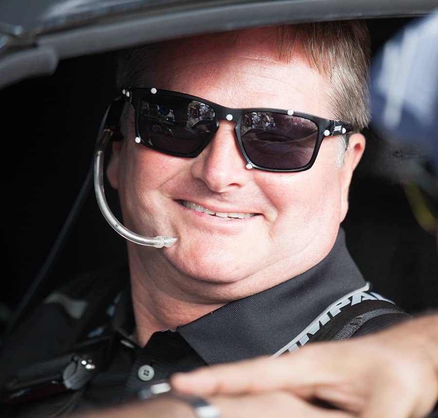 Sam Schmidt mugs from behind the wheel, where he belongs.