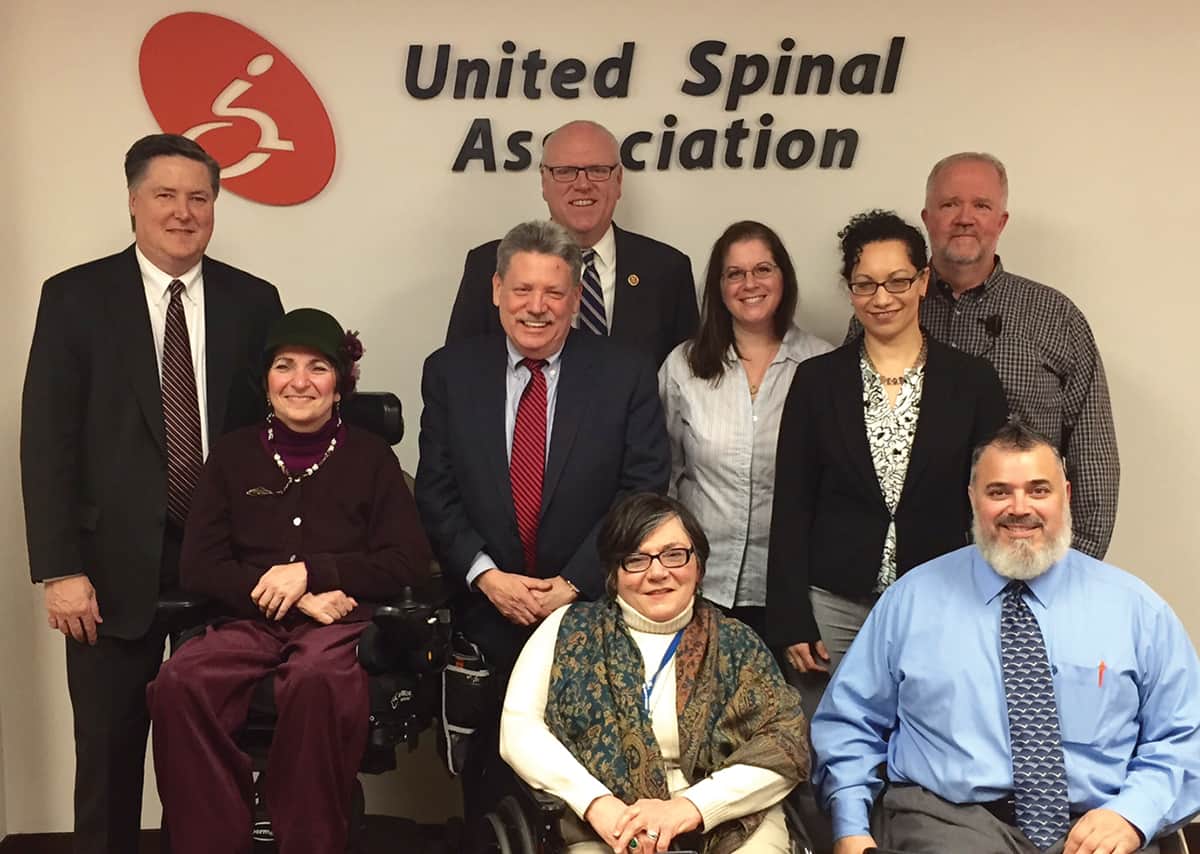 Congressman Joe Crowley (center, back row), a strong supporter, visited United Spinal’s new offices.