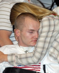 Vets_4 Matt (pictured hugging Tracy) says, "Because I have a very visible injury and I'm in a power chair, people in public want to come up and have their picture taken with me. 'There's a hero,' they say."