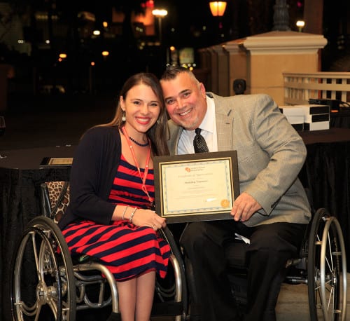 Nick LiBassi, United Spinal’s director of chapter relations, presents Kristina Rhoades of MV-1 an award for the company’s sponsorship of the Chapter Leadership Meeting and United Spinal.