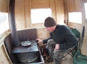 The portable shed has a wood stove and windows at the right height for viewing wildlife.