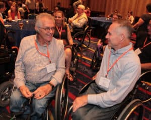 Pat Maher, right, chats with fellow United Spinal board member Marty Ball at the welcoming reception.