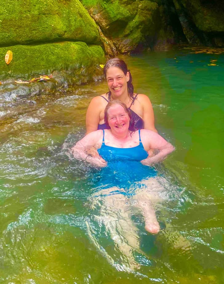 Rhonda Neuhaus is assisted in swimming in a waterfall in Costa Rica .
