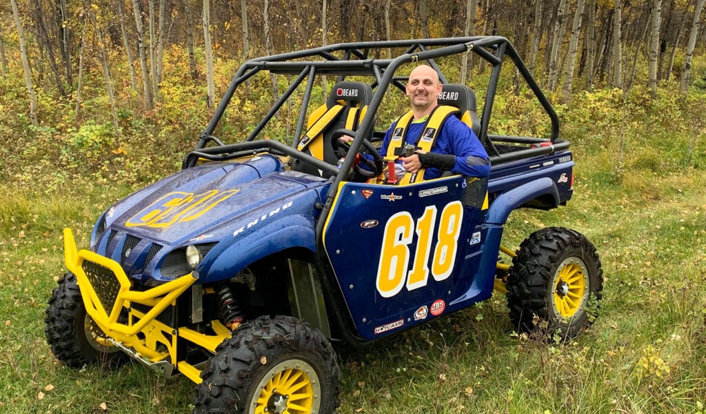 Landon sitting in his Rhino ATV
