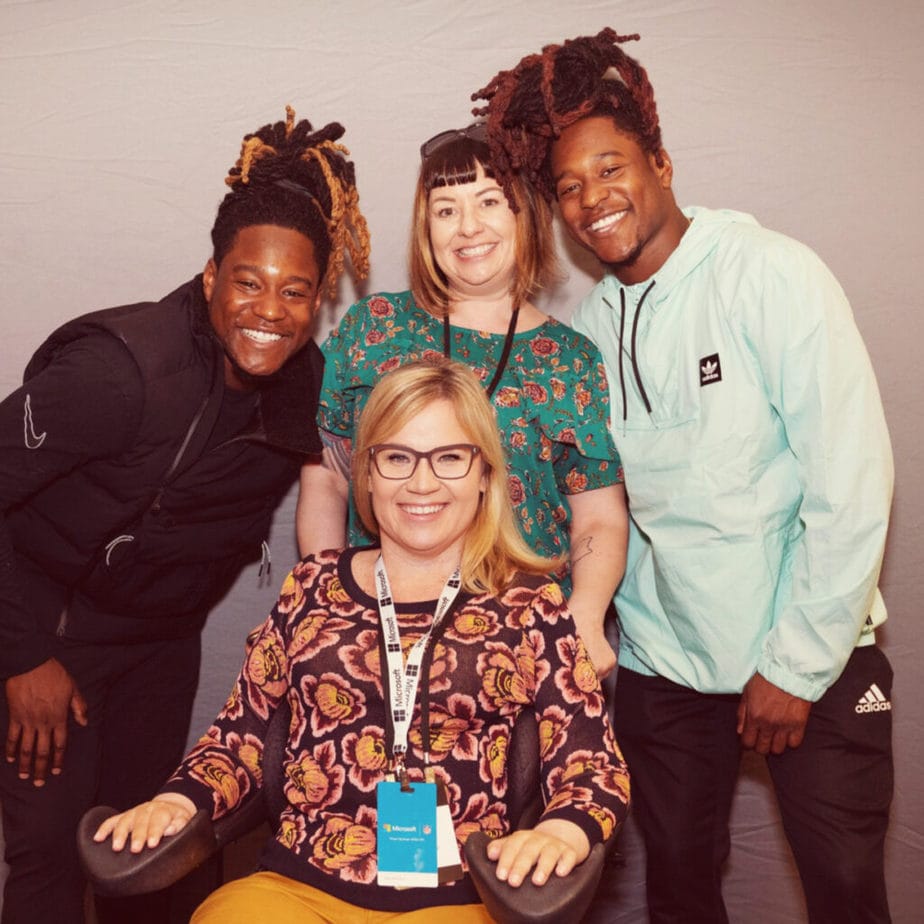 Brook McCall (center) is passionate about connecting tech professionals to United  Spinal members. Here she and her caregiver, Stacie Perry, are featured with NFL stars Shaquem and Shaquill Griffin at the Microsoft Ability Summit.