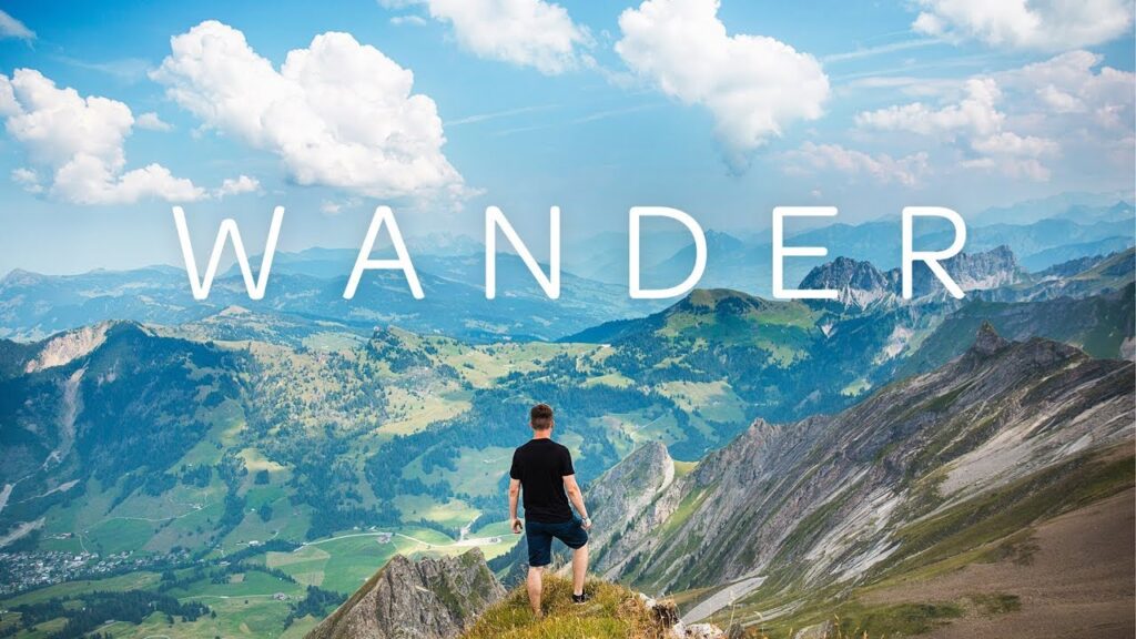 Promo for Wander appp showing a man standing on top of a mountain