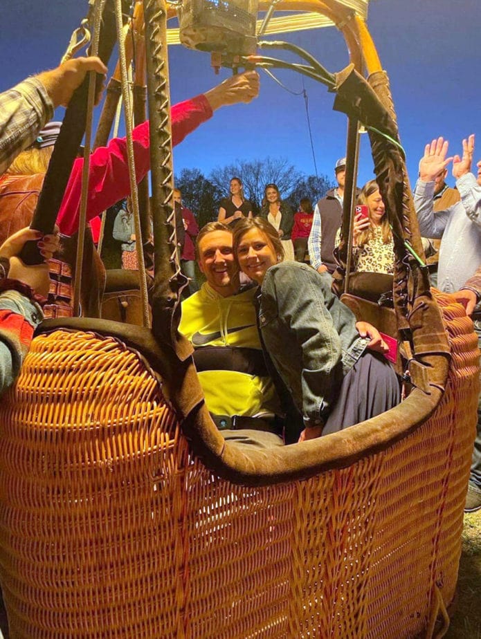 couple in hot air balloon basket