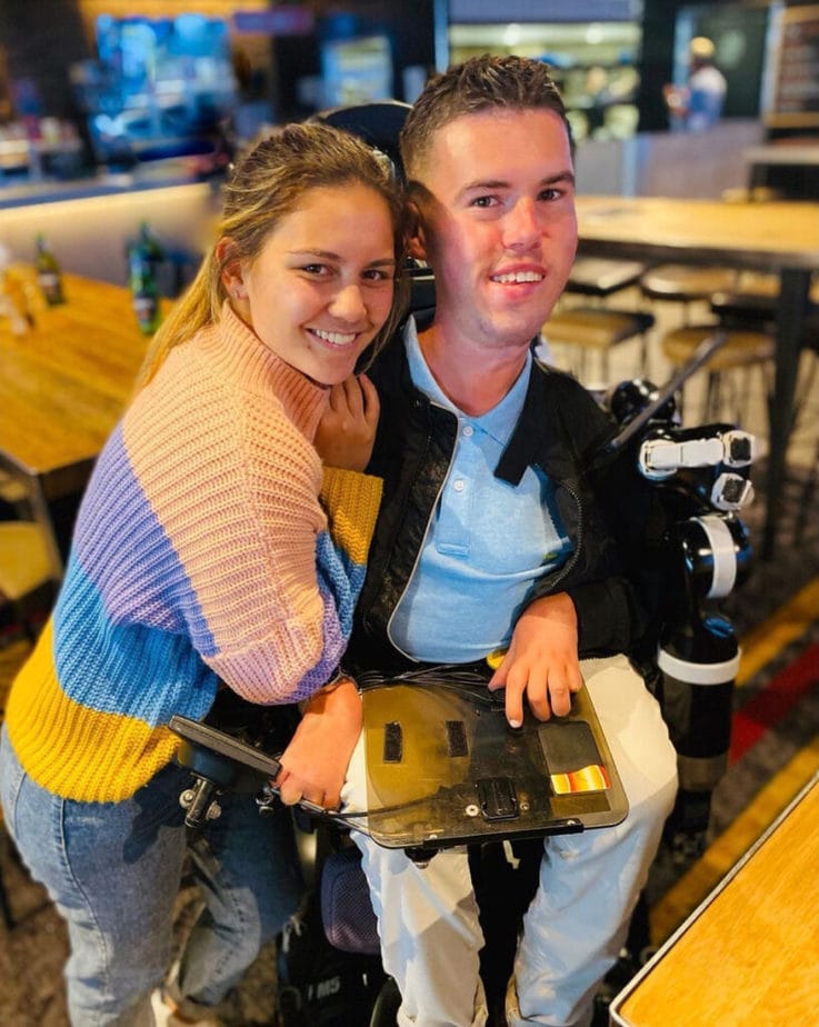 woman hugging man in wheelchair