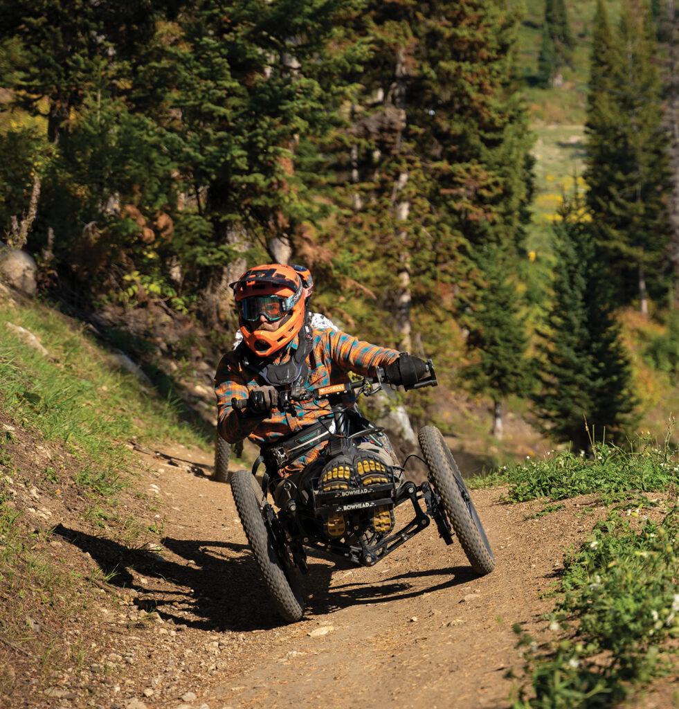 man on accessible ATV riding on trail in forrest