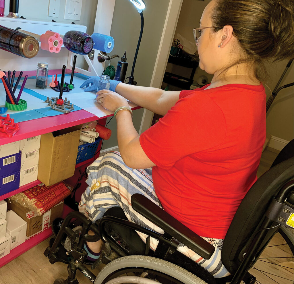 woman in powerchair crafting at her desk