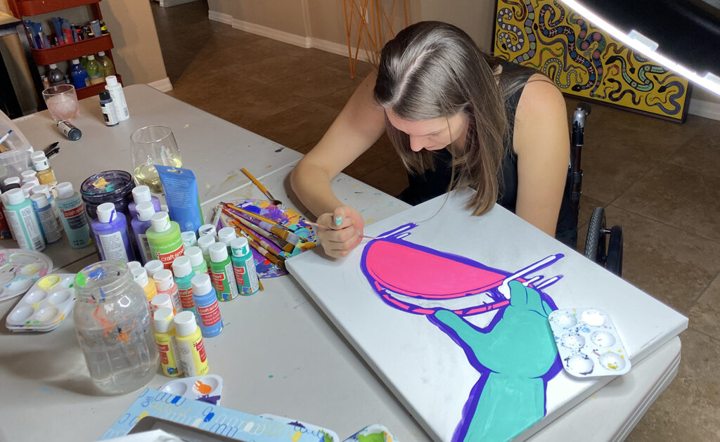 female artist painting on canvas