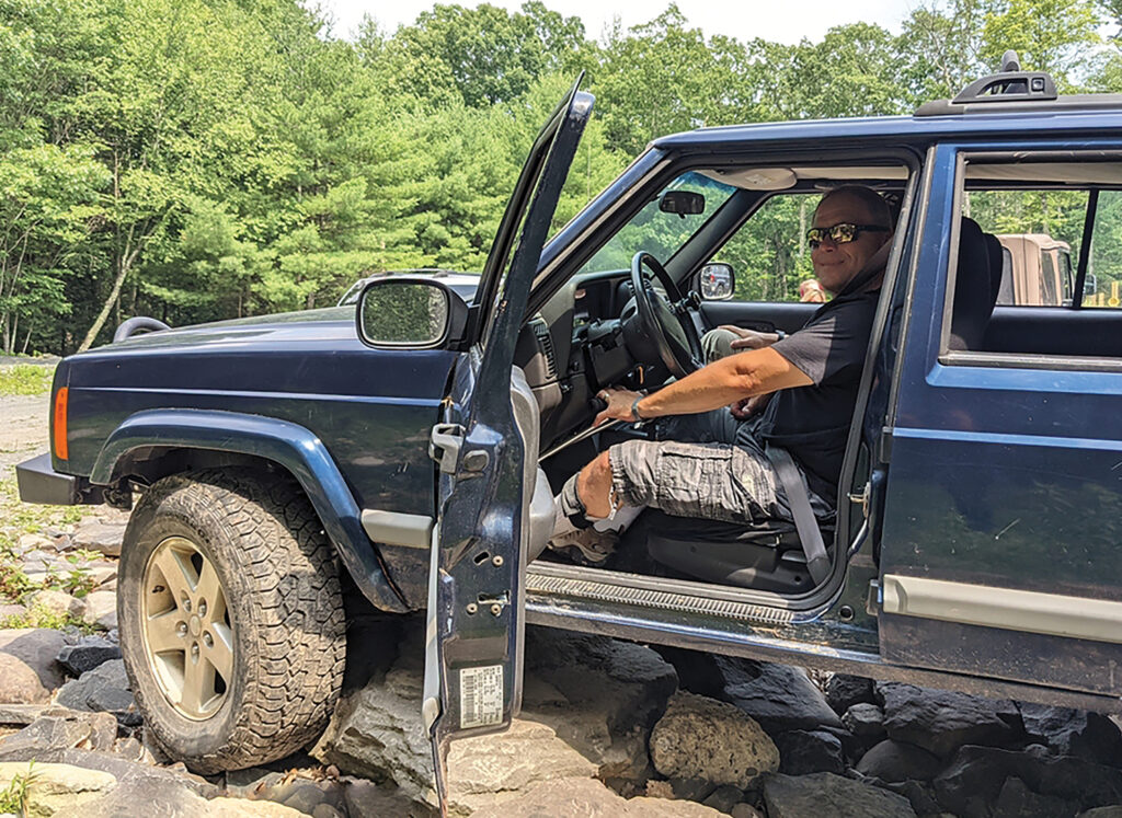 author behind the wheel of accessible vehicle to go off-roading