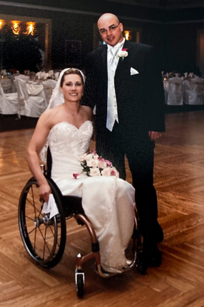 bride in wheelchair with groom wedding photo taken on dance floor