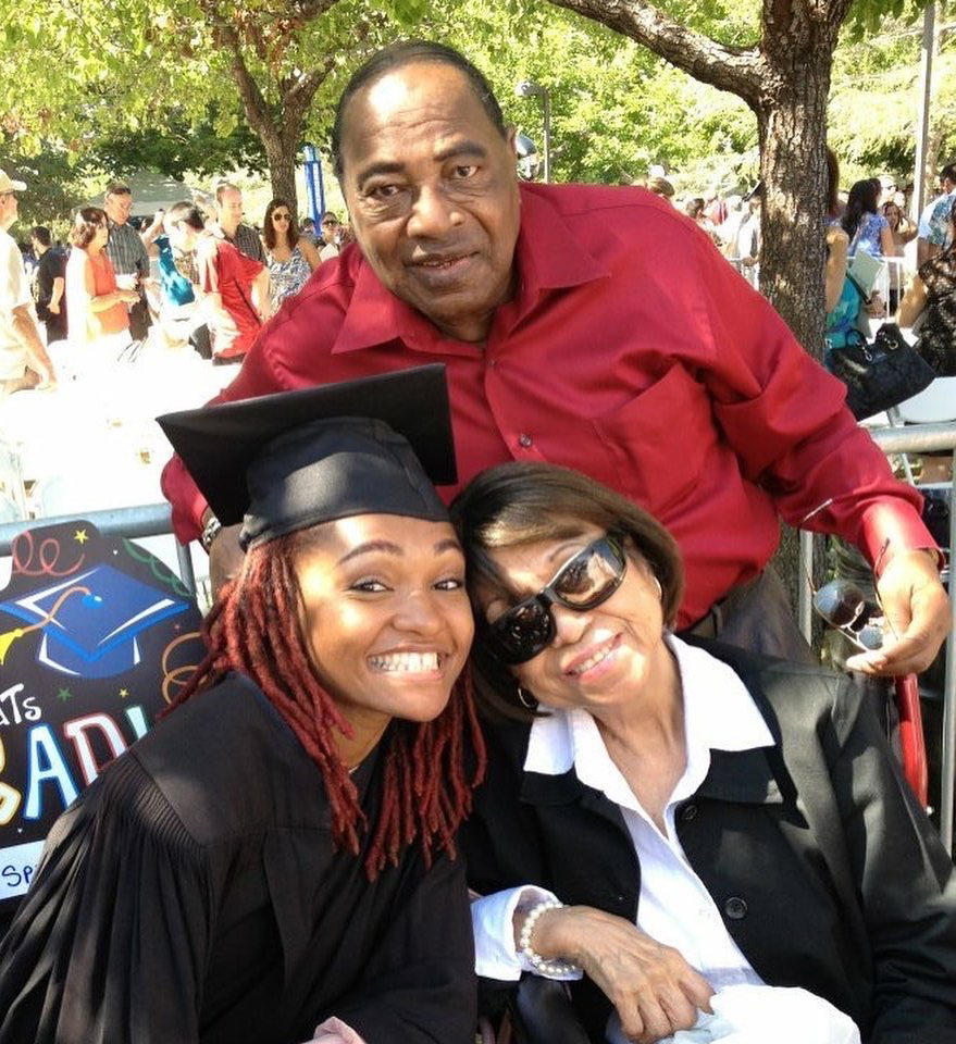 Spencer wearing cap and gown, pictured with grandmother and grandfather 
