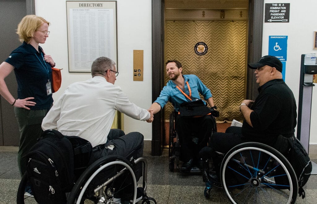 Group pictured in front of elevator