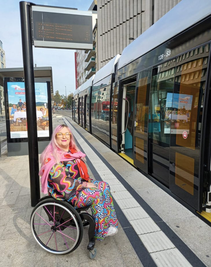 woman in wheelchair on train platform
