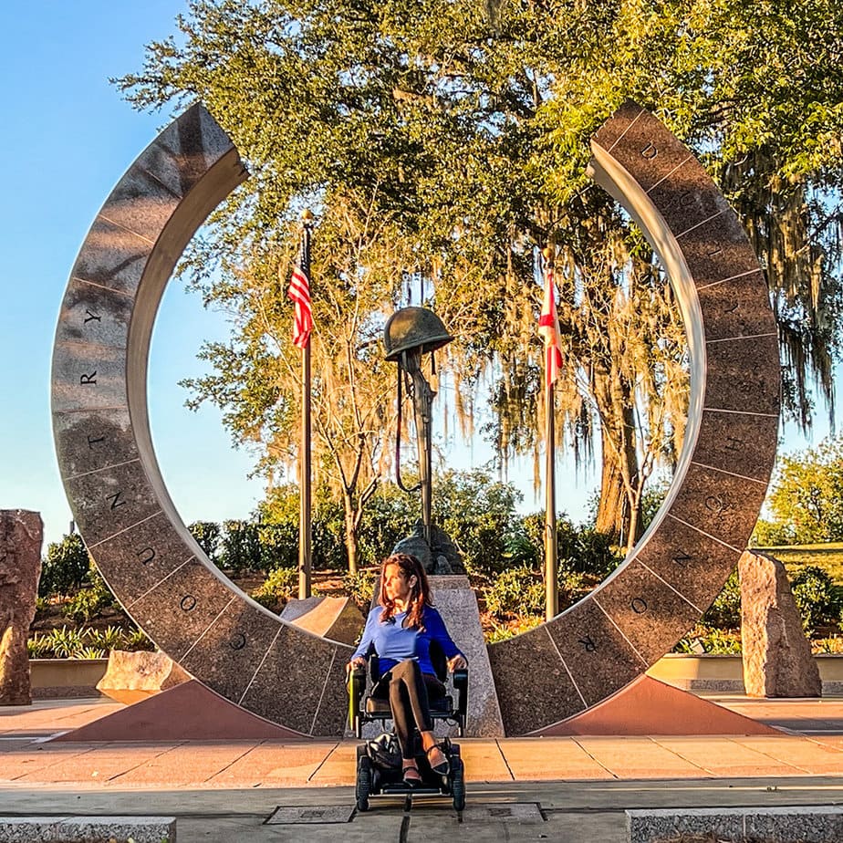 woman in wheelchair pictured in front of Korean War memorial