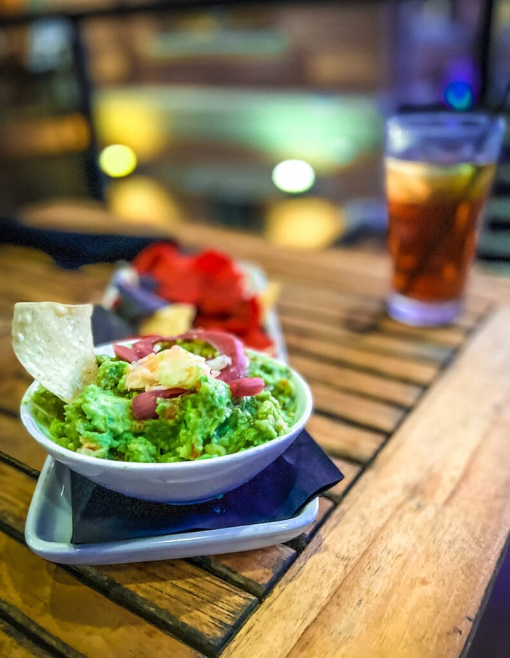bowl of guacamole displayed on table