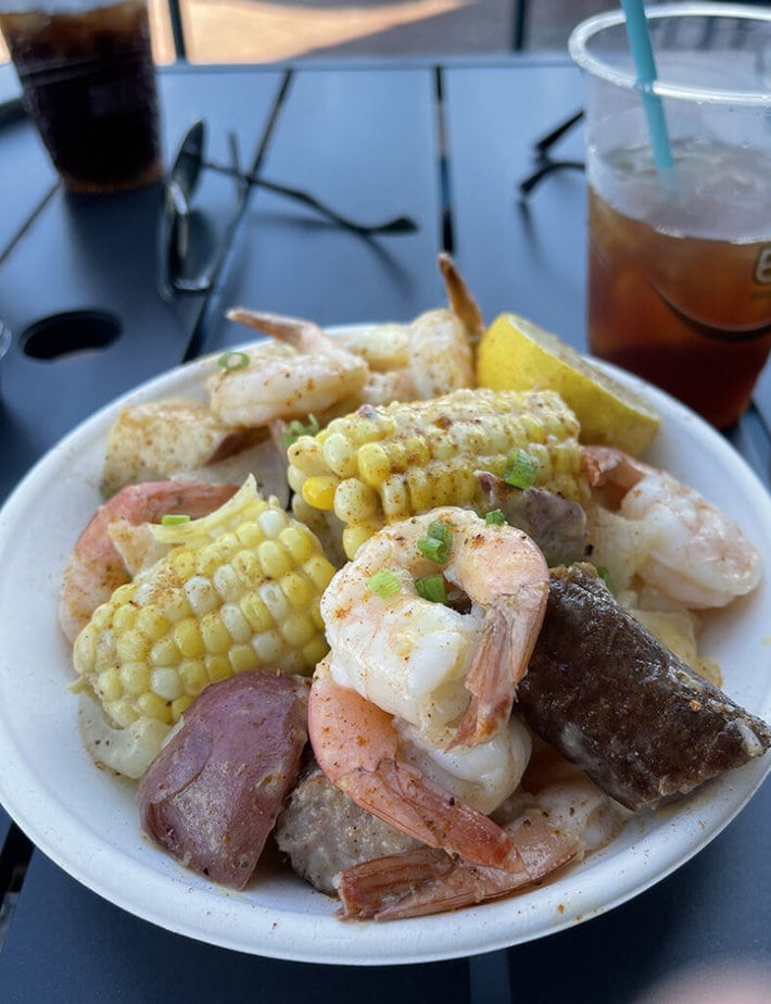 dish featuring corn on the cob, shrimp, sausage and potatoes