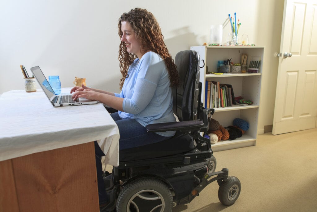woman in oowerchair using a laptop