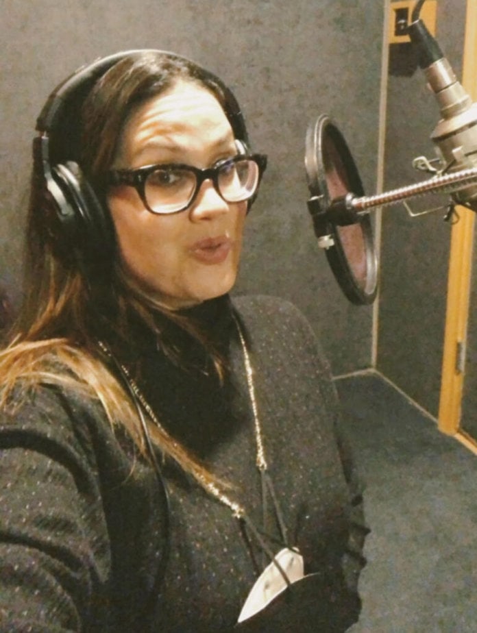 woman wearing headset in recording booth