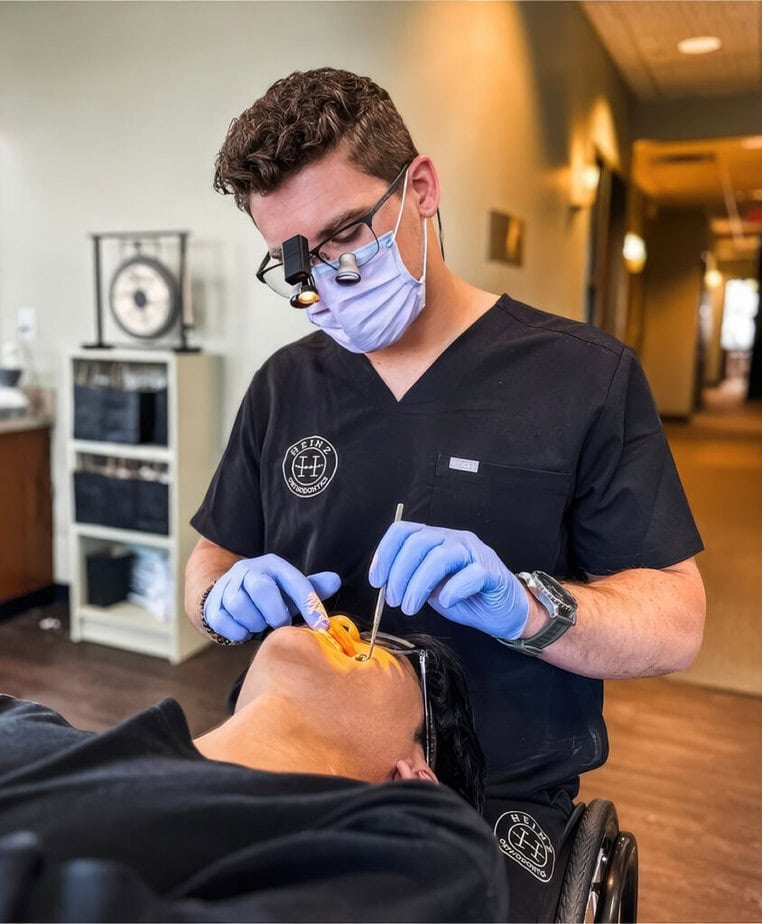 make dentist in wheelchair working in patient's mouth