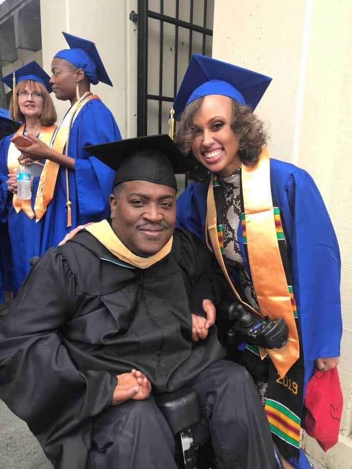 Graduation ceremony with graduates in blue caps and gowns