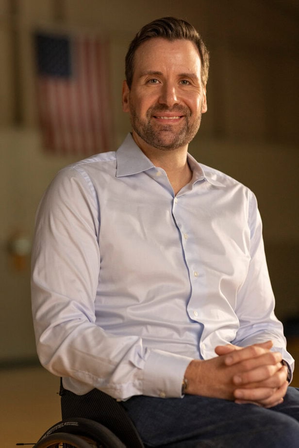 portrait of smiling man sitting in wheelchair