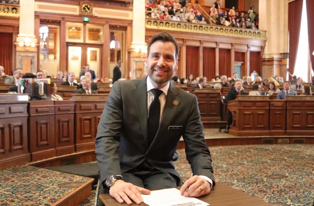 man in wheelchair signing legislation